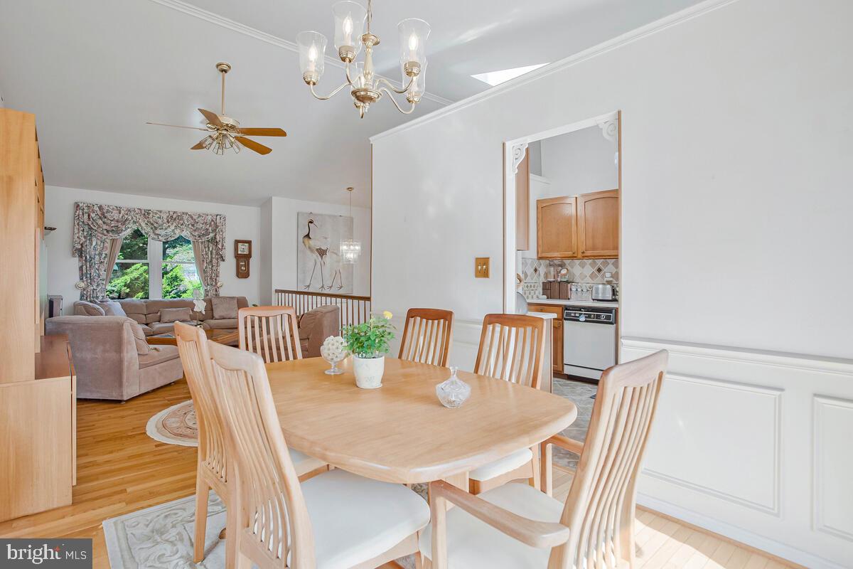 674 Teton Drive Lothian, MD 20711 - Photo 8 of 38 a view of a dining room with furniture a chandelier and wooden floor