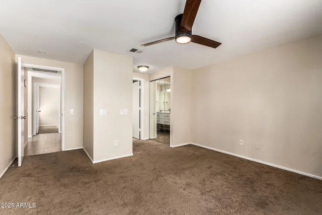 a bathroom with a granite countertop toilet sink and a mirror