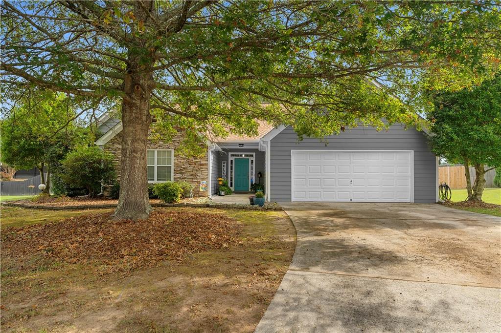 2553 Harvest Moon Court Southwest Powder Springs, GA 30127 - Photo 1 of 1 a front view of a house with a yard and a garage