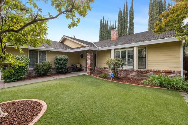 a front view of a house with a yard and porch