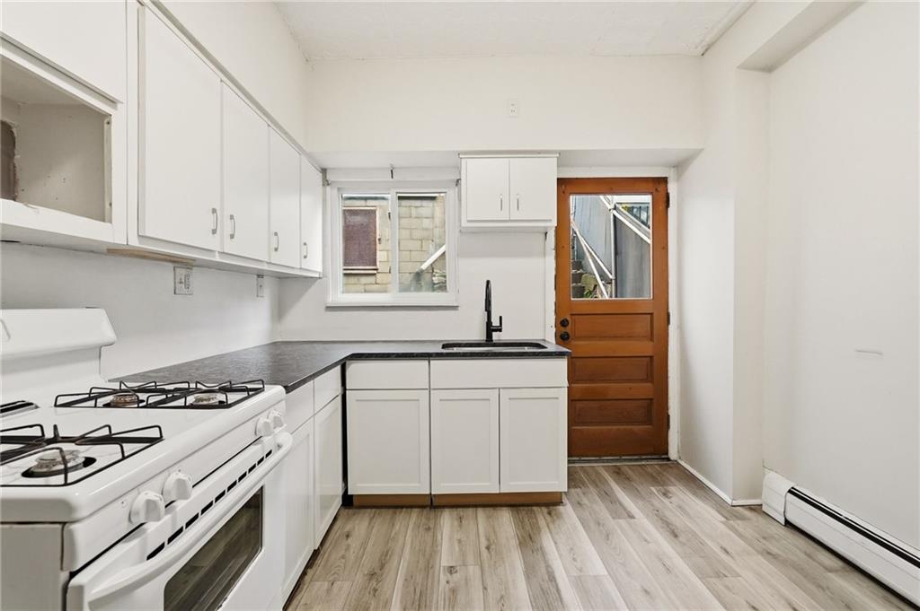 3468 Ligonier Street Pittsburgh, PA 15201 - Photo 11 of 33 a kitchen with granite countertop a stove and a sink