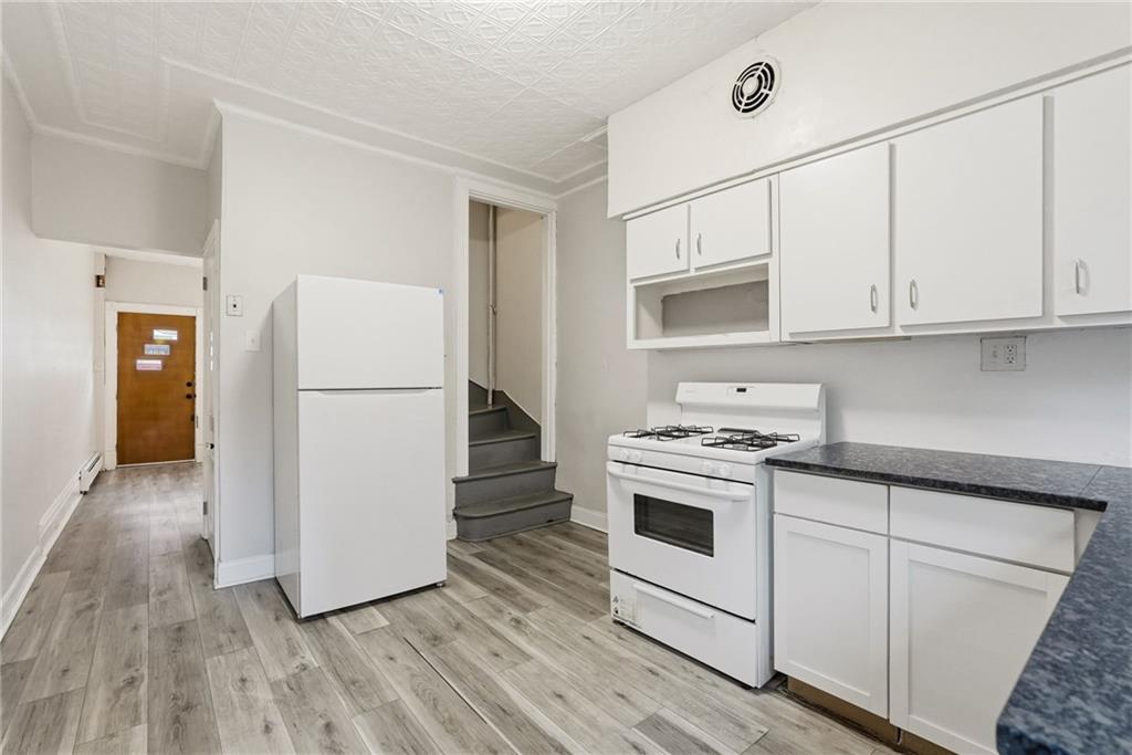 3468 Ligonier Street Pittsburgh, PA 15201 - Photo 12 of 33 a kitchen with a refrigerator sink and cabinets