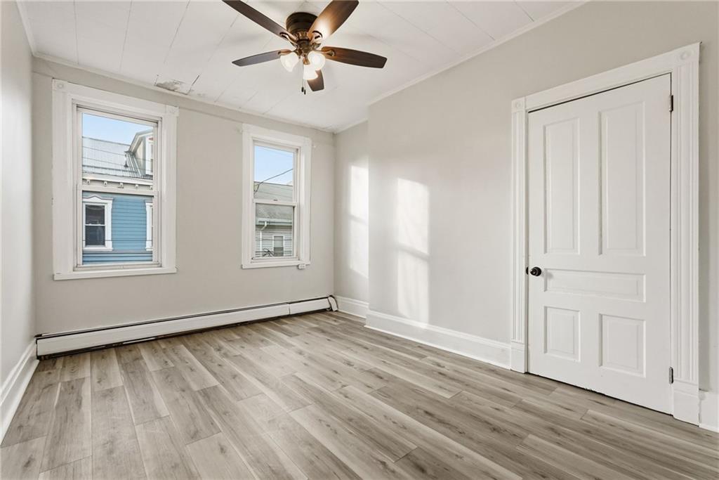 3468 Ligonier Street Pittsburgh, PA 15201 - Photo 14 of 33 a view of an empty room with wooden floor and a window
