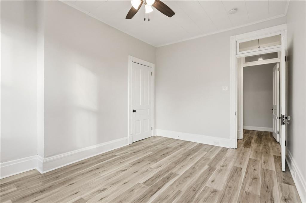 3468 Ligonier Street Pittsburgh, PA 15201 - Photo 15 of 33 an empty room with wooden floor chandelier fan and windows