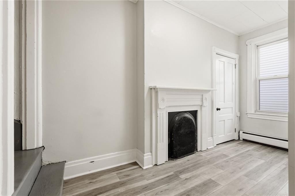 3468 Ligonier Street Pittsburgh, PA 15201 - Photo 16 of 33 a view of a livingroom with a fireplace window and a ceiling fan