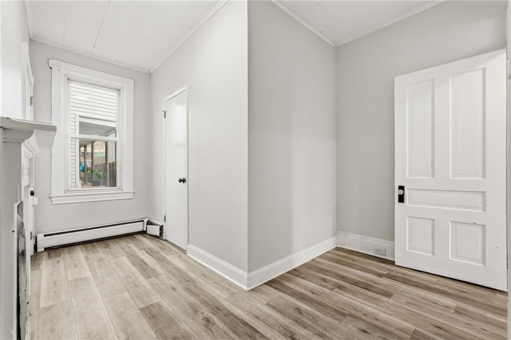 3468 Ligonier Street Pittsburgh, PA 15201 - Photo 18 of 33 an empty room with wooden floor and windows