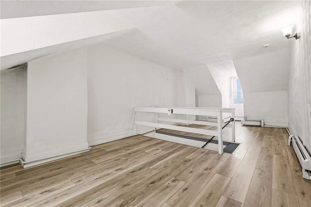 3468 Ligonier Street Pittsburgh, PA 15201 - Photo 21 of 33 a view of a room with wooden floor and white walls