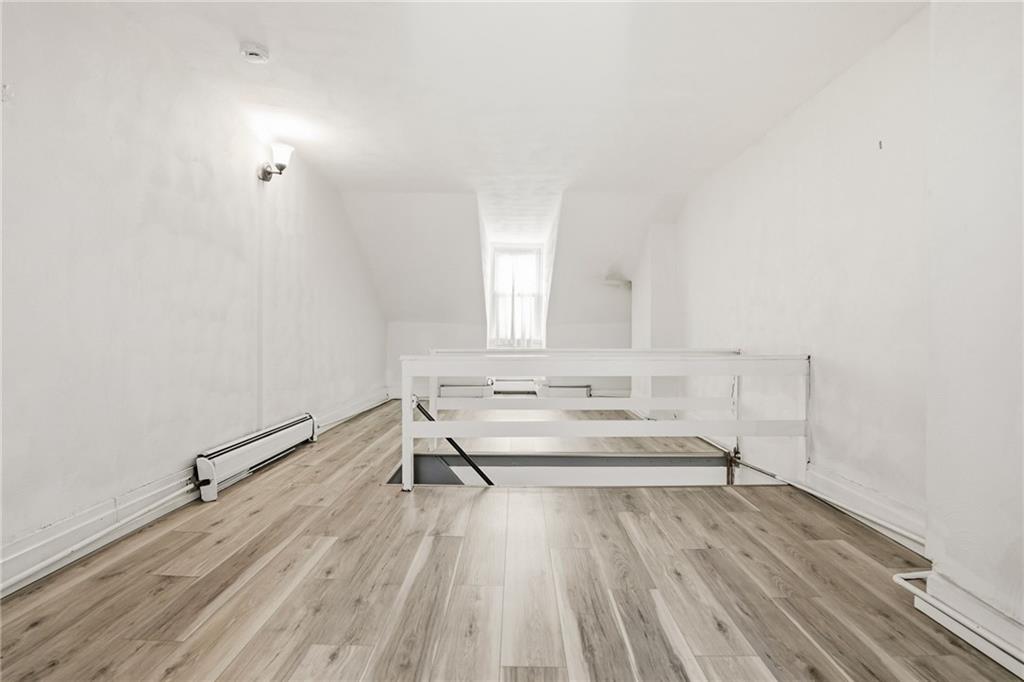 3468 Ligonier Street Pittsburgh, PA 15201 - Photo 22 of 33 a view of a room with wooden floor and white walls