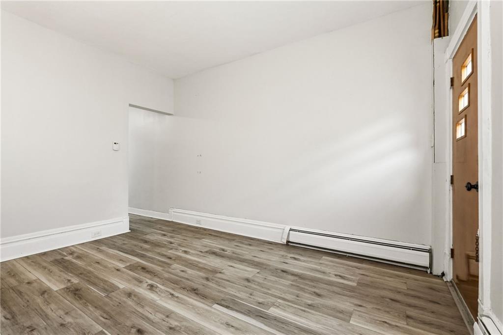 3468 Ligonier Street Pittsburgh, PA 15201 - Photo 8 of 33 an empty room with wooden floor and windows