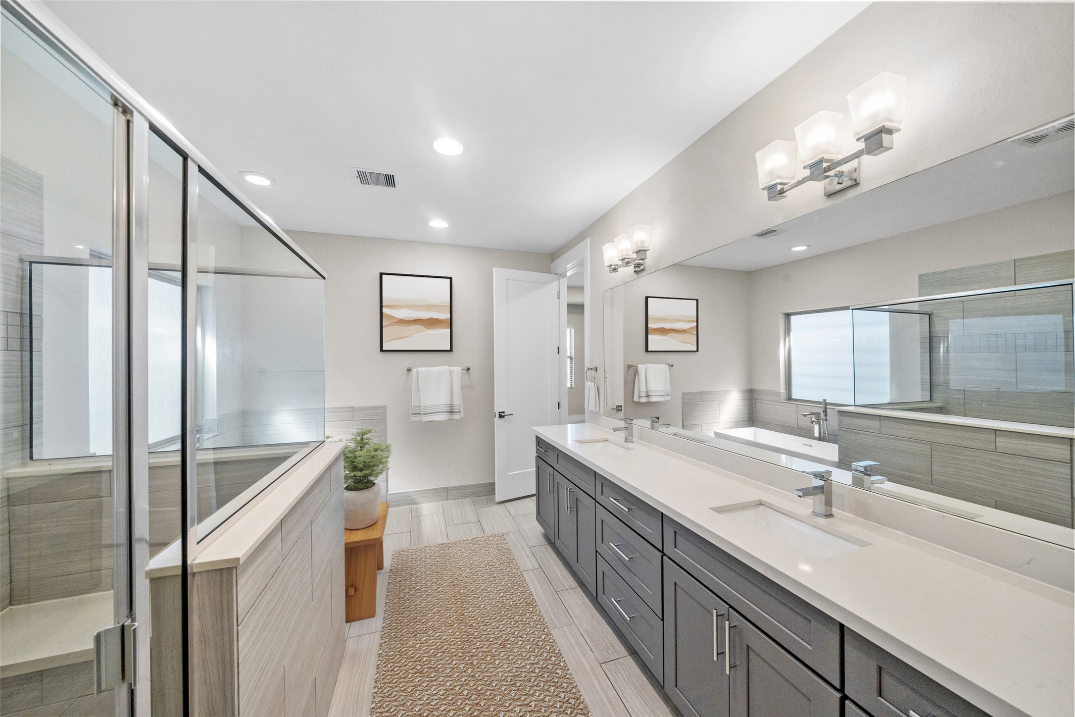 1707 Freeman Street Houston, TX 77009 - Photo 12 of 20 a spacious bathroom with a double vanity sink a mirror and a shower