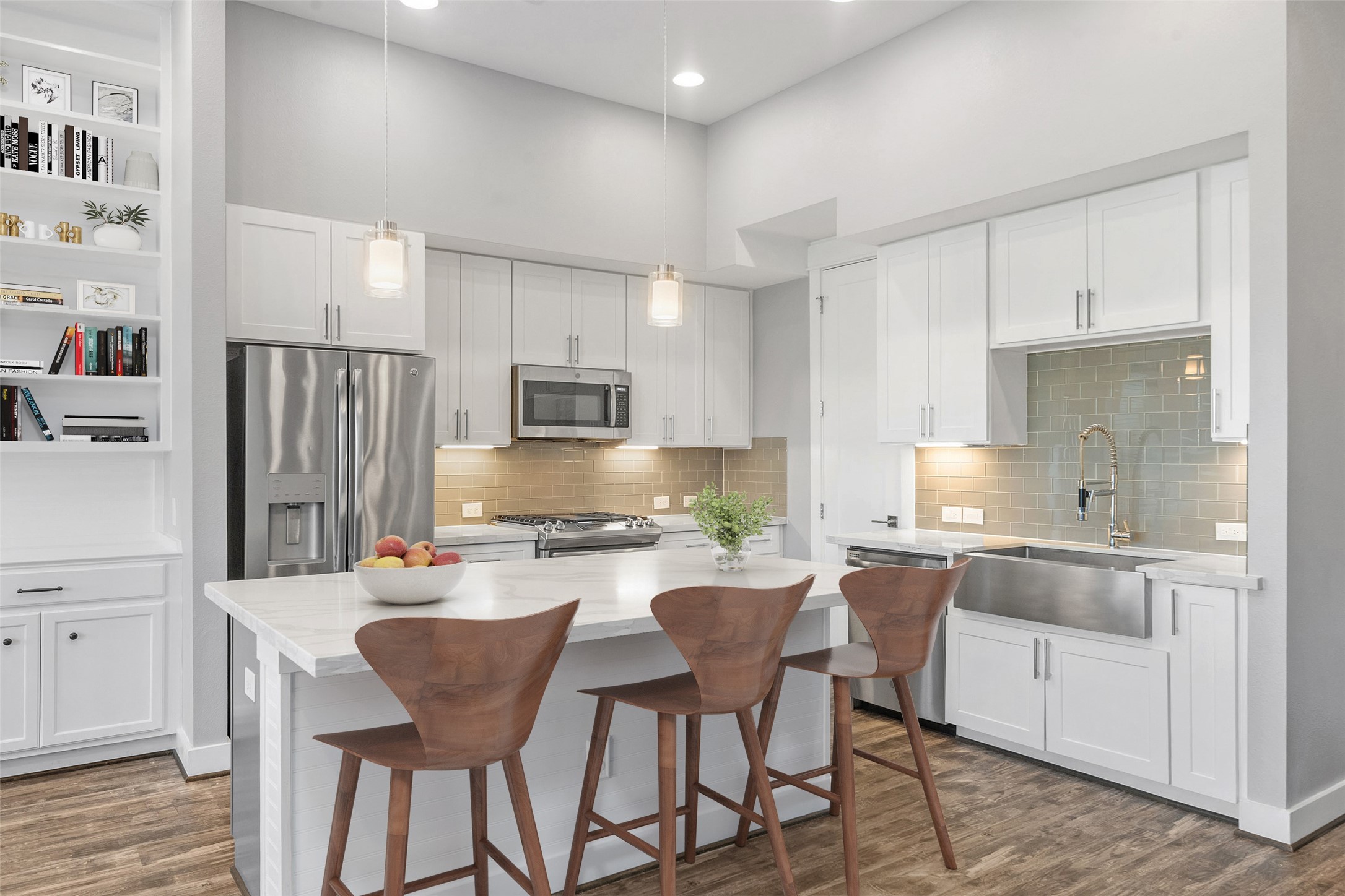 1707 Freeman Street Houston, TX 77009 - Photo 2 of 20 a kitchen with stainless steel appliances a sink a stove a refrigerator cabinets and chairs