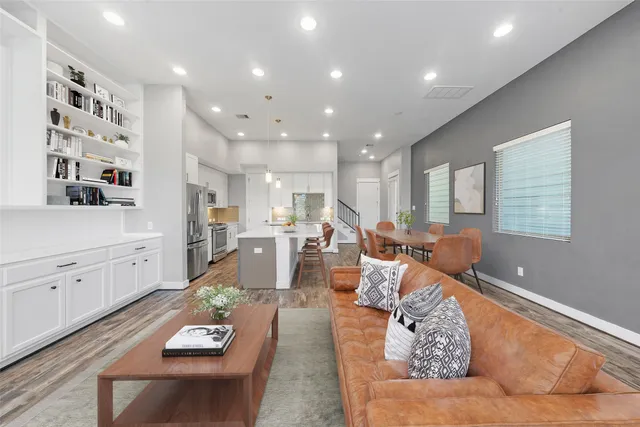 a living room with furniture and wooden floor