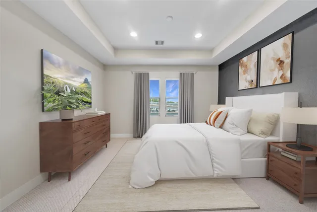 a spacious bedroom with a large bed and a window