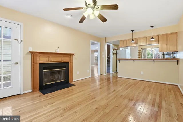 a view of a kitchen a ceiling fan wooden floor and a kitchen