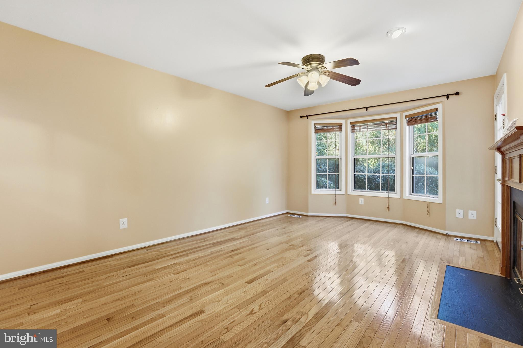 8341 Marketree Circle Montgomery Village, MD 20886 - Photo 16 of 43 a view of an empty room with wooden floor and a window