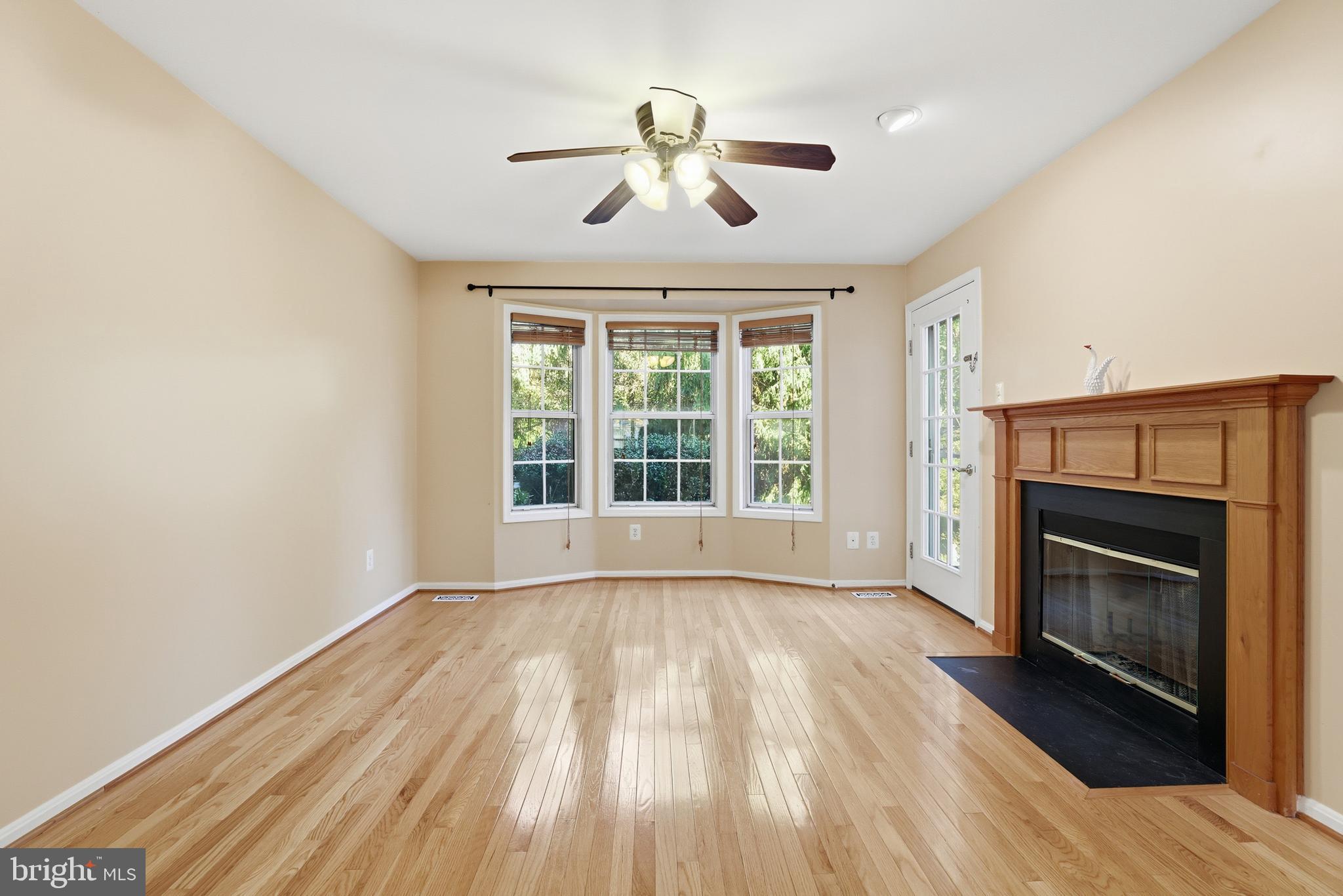 8341 Marketree Circle Montgomery Village, MD 20886 - Photo 17 of 43 a view of empty room with wooden floor and fireplace