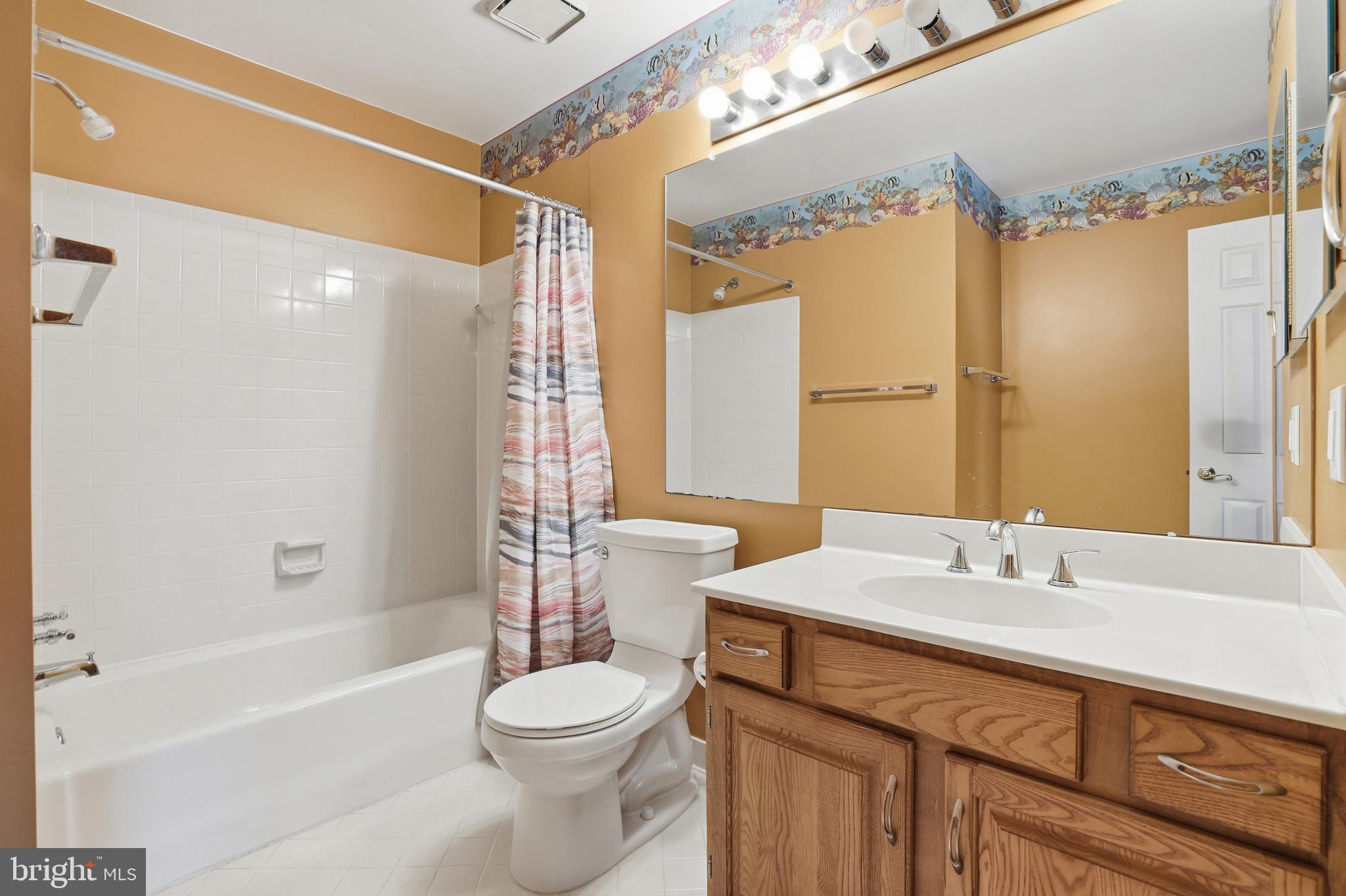 8341 Marketree Circle Montgomery Village, MD 20886 - Photo 29 of 43 a bathroom with a sink a toilet a mirror a bathtub and shower