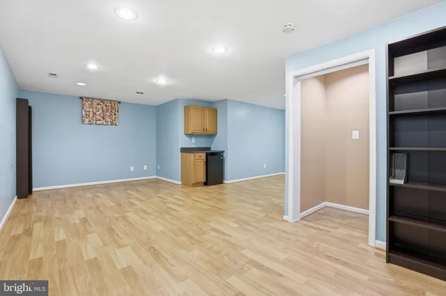 a view of empty room with a fireplace and wooden floor