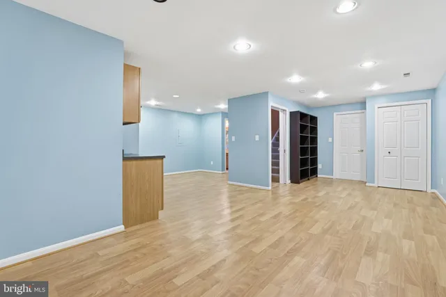 a view of an empty room with a kitchen