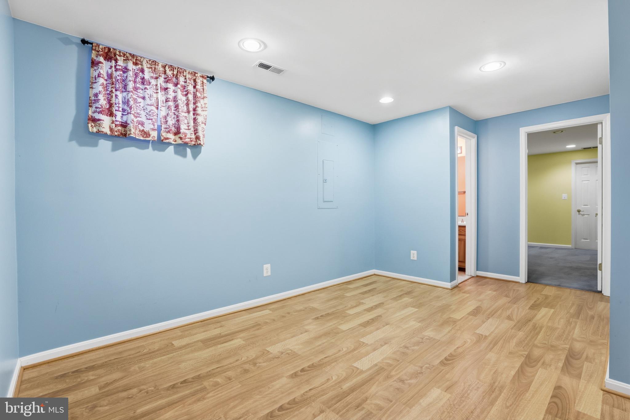 8341 Marketree Circle Montgomery Village, MD 20886 - Photo 34 of 43 a view of a big room with wooden floor and windows