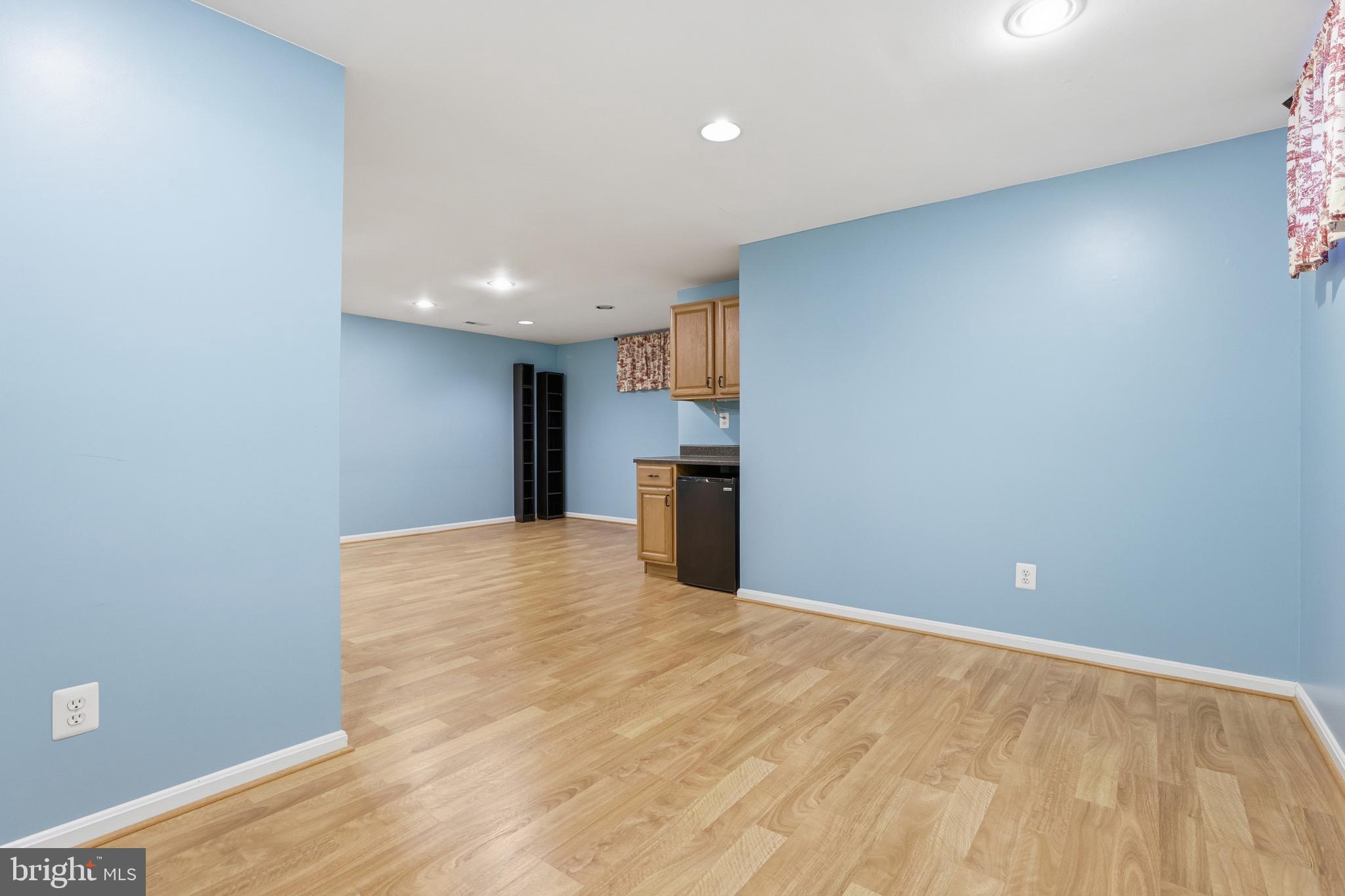 8341 Marketree Circle Montgomery Village, MD 20886 - Photo 35 of 43 a view of empty room with wooden floor and kitchen