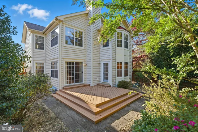 a view of a house with a small yard and flower plants