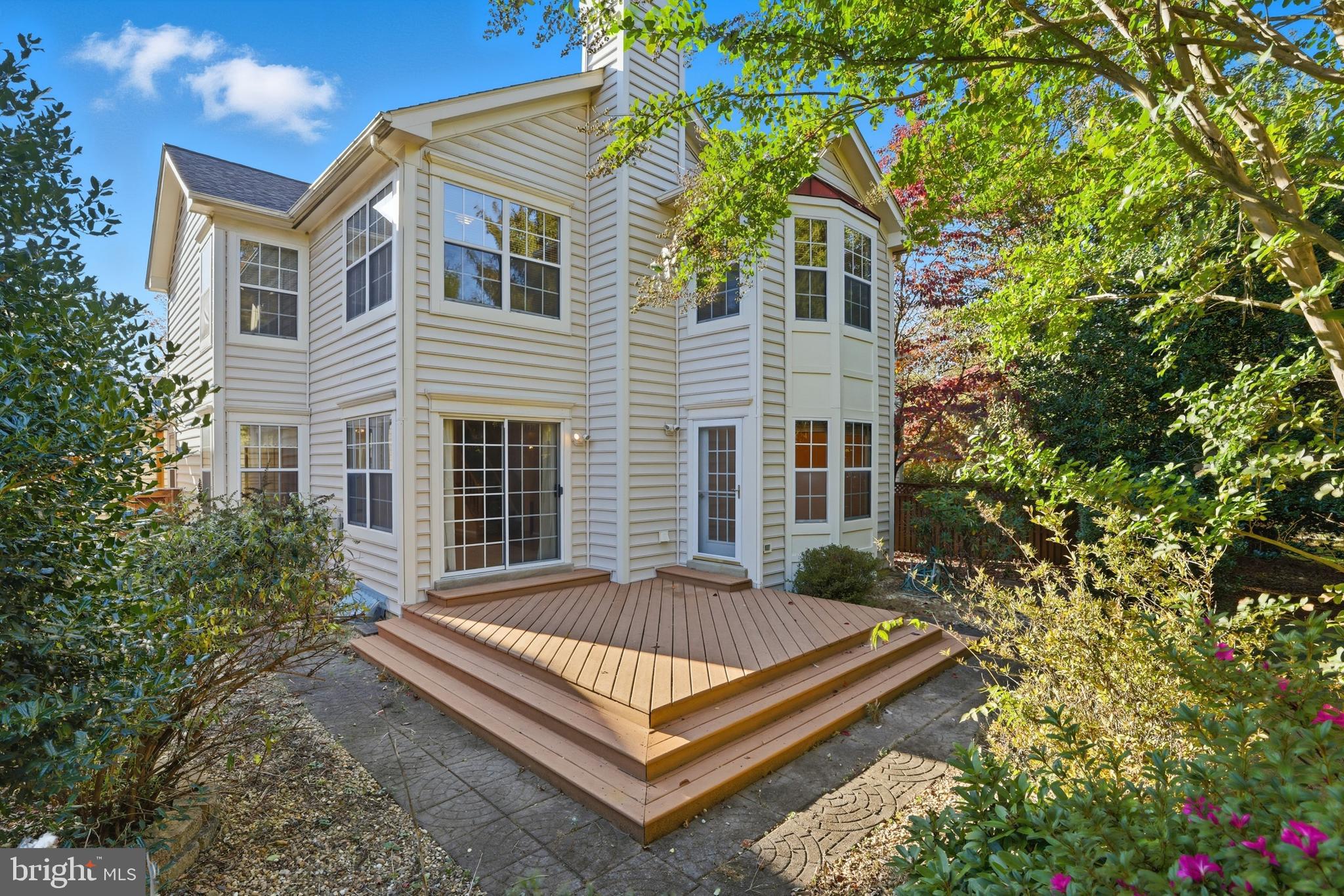 8341 Marketree Circle Montgomery Village, MD 20886 - Photo 41 of 43 a view of a house with a small yard and flower plants