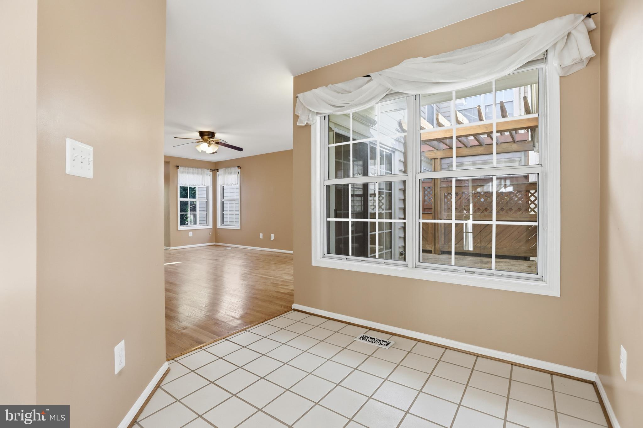 8341 Marketree Circle Montgomery Village, MD 20886 - Photo 5 of 43 a view of an empty room with wooden floor and a window