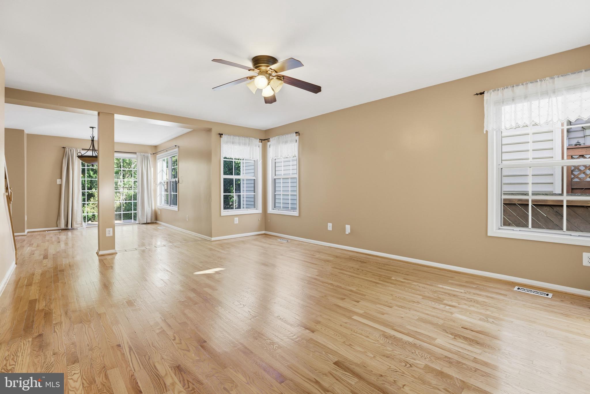 8341 Marketree Circle Montgomery Village, MD 20886 - Photo 6 of 43 a view of an empty room with wooden floor and a window