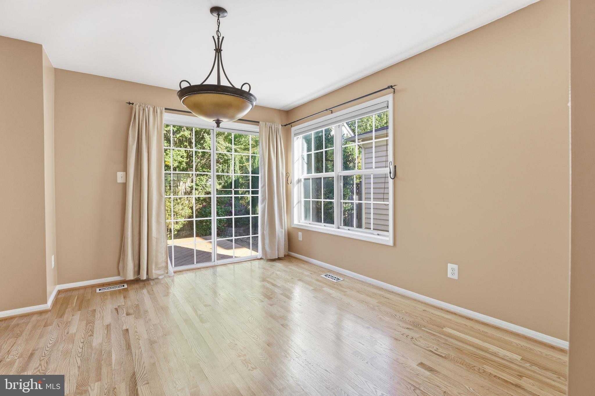 8341 Marketree Circle Montgomery Village, MD 20886 - Photo 9 of 43 a view of an empty room with wooden floor and a window