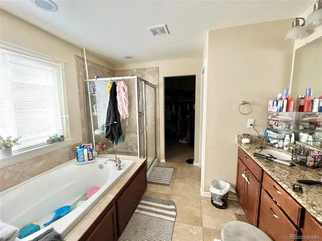 a bathroom with a tub and a sink