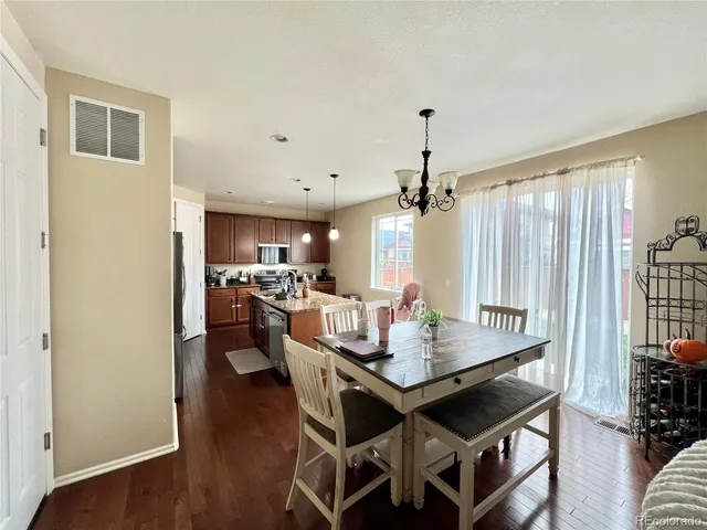 a dining room with furniture window and wooden floor