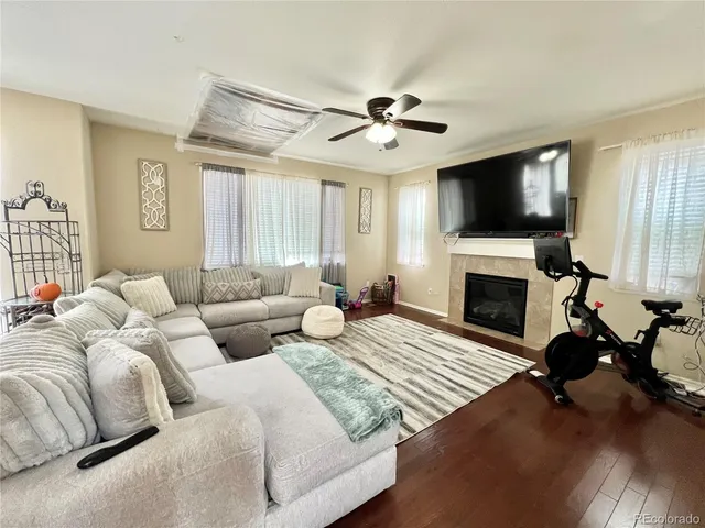 a living room with furniture flat screen tv and a fireplace