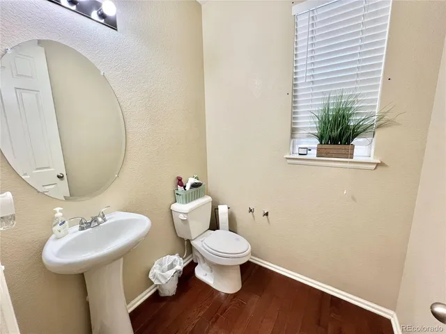 a bathroom with a sink toilet and a mirror