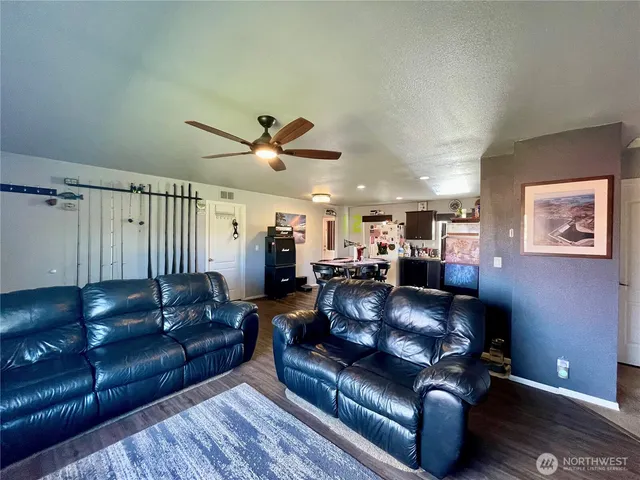 a living room with furniture and a ceiling fan