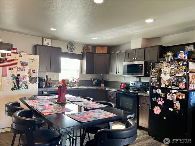 a kitchen with a dining table and chairs