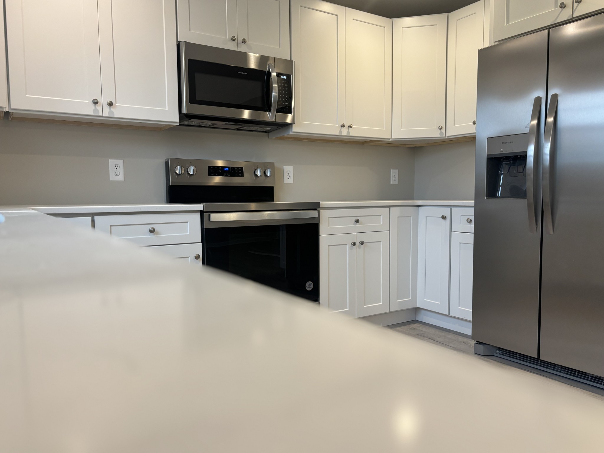 2079 Old Well Road Morrison, TN 37357 - Photo 5 of 23 a kitchen with stainless steel appliances granite countertop a refrigerator a stove a sink and white cabinets
