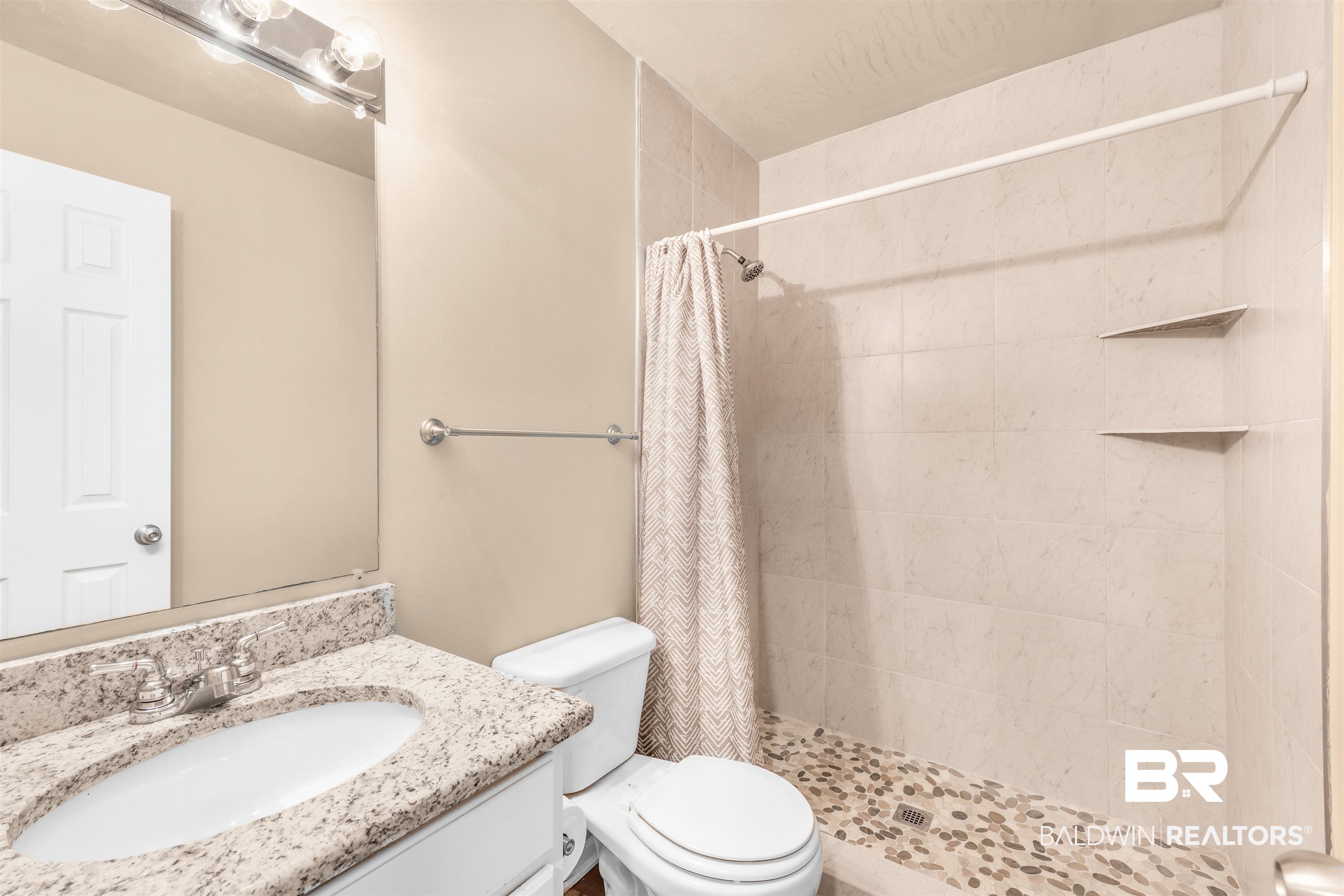 1517 Regency Road, Unit 85 Gulf Shores, AL 36542 - Photo 12 of 32 Bathroom with curtained shower, vanity, and toilet