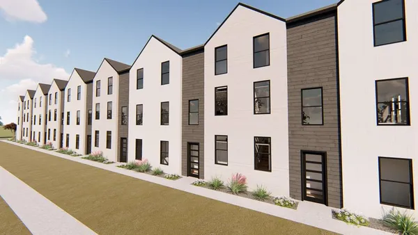 a front view of a house with a yard and fountain
