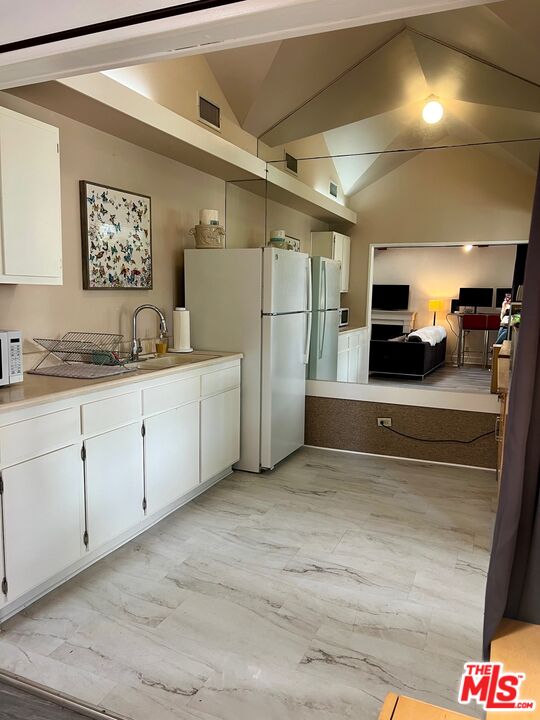 Carmelita Avenue Beverly Hills, CA 90210 - Photo 11 of 14 a kitchen with a sink and a refrigerator