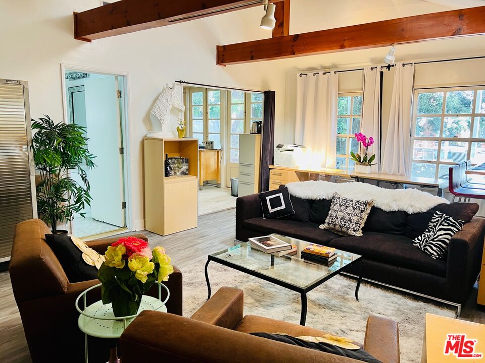 Carmelita Avenue Beverly Hills, CA 90210 - Photo 2 of 14 a living room with furniture and a potted plant