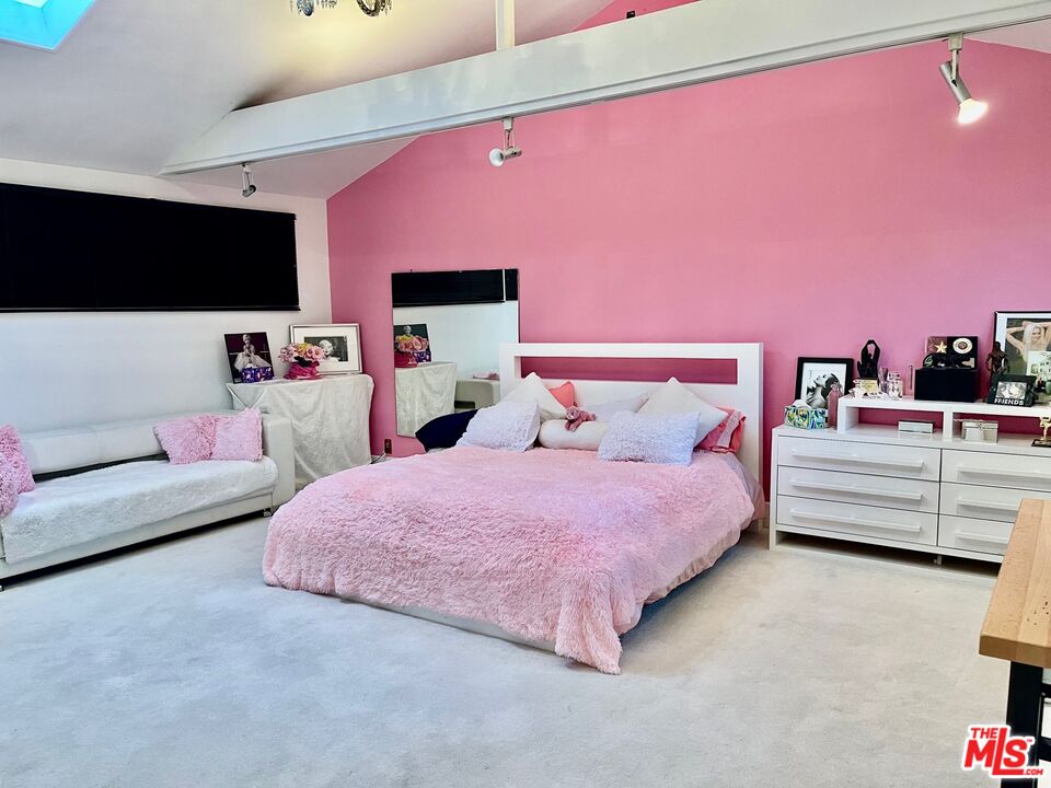 Carmelita Avenue Beverly Hills, CA 90210 - Photo 7 of 14 a bedroom with a bed and a flat screen tv