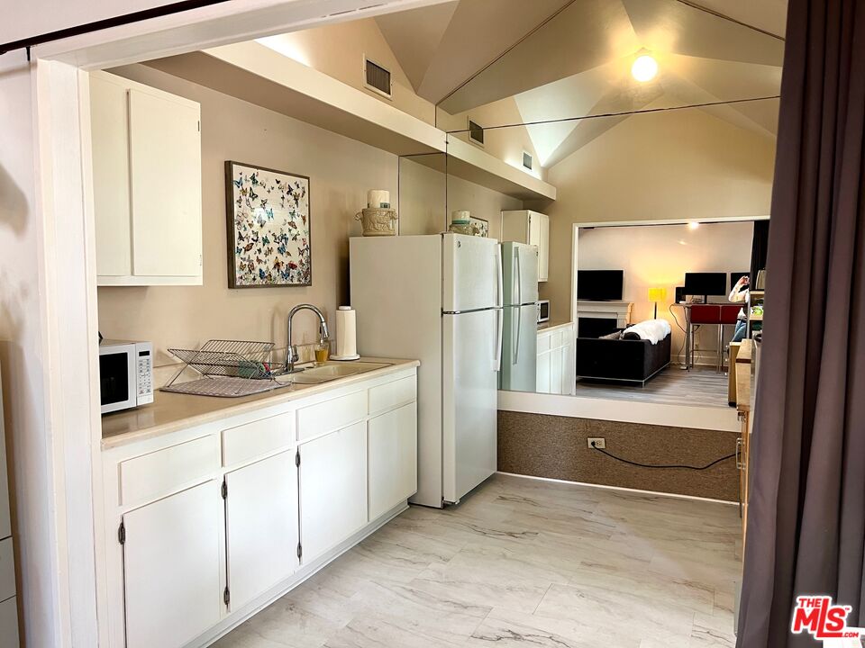 Carmelita Avenue Beverly Hills, CA 90210 - Photo 9 of 14 a kitchen with refrigerator and cabinets