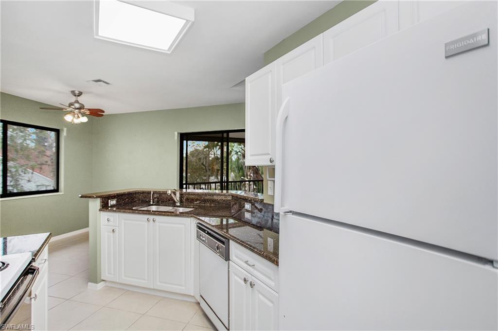 191 Bennington Drive, Unit 124 Naples, FL 34104 - Photo 17 of 26 a kitchen with a sink and cabinets