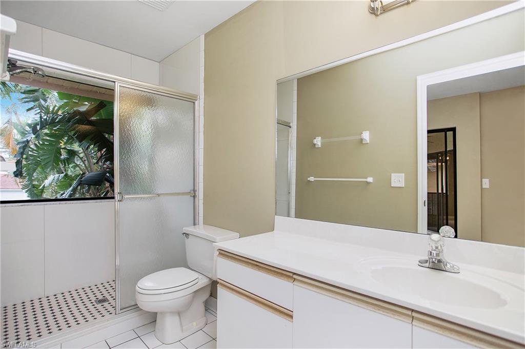 191 Bennington Drive, Unit 124 Naples, FL 34104 - Photo 20 of 26 a bathroom with a sink a toilet and shower