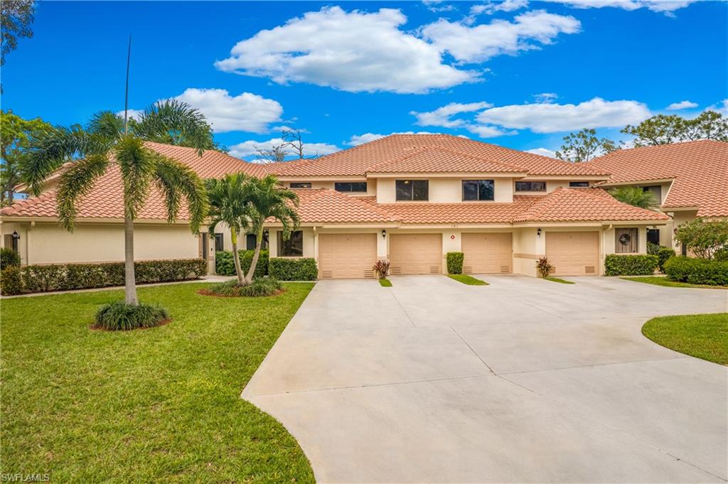 191 Bennington Drive, Unit 124 Naples, FL 34104 - Photo 2 of 26 a front view of a house with a yard