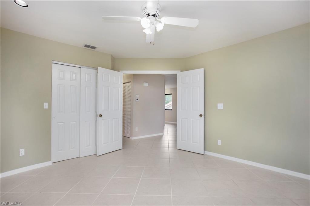 191 Bennington Drive, Unit 124 Naples, FL 34104 - Photo 21 of 26 a view of an empty room and chandelier fan