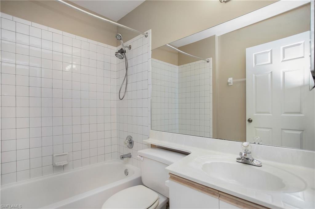 191 Bennington Drive, Unit 124 Naples, FL 34104 - Photo 23 of 26 a bathroom with a sink toilet and shower