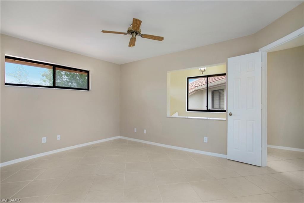 191 Bennington Drive, Unit 124 Naples, FL 34104 - Photo 6 of 26 a view of a livingroom with a ceiling fan and window