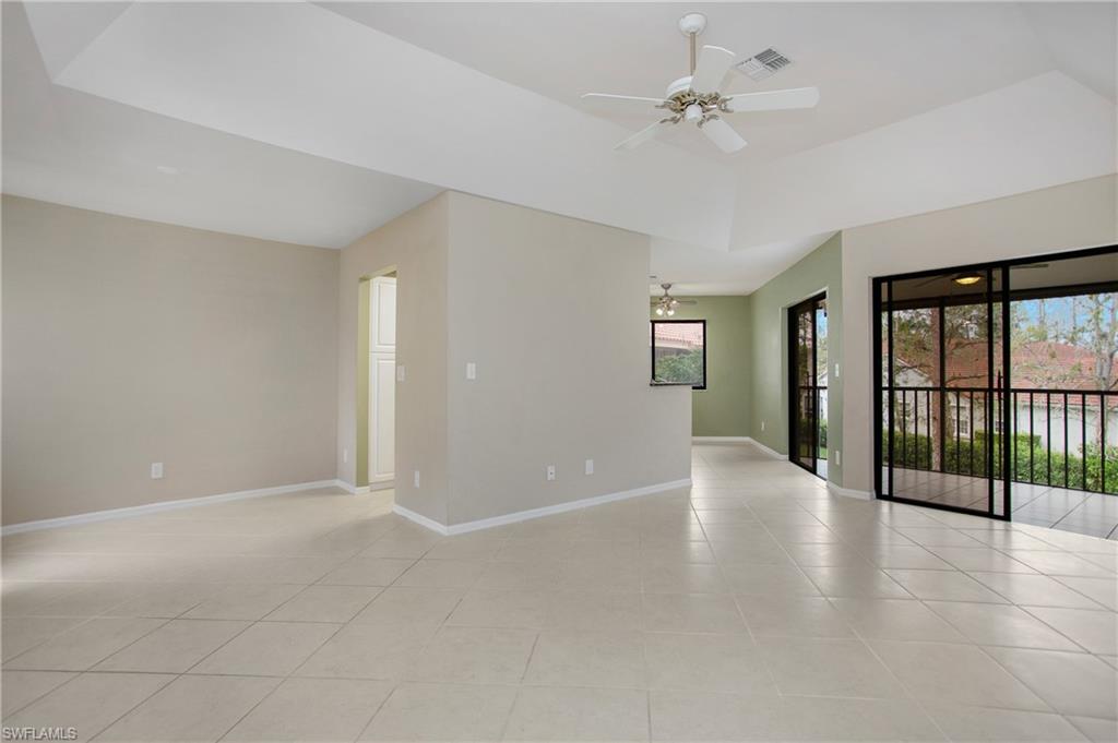 191 Bennington Drive, Unit 124 Naples, FL 34104 - Photo 8 of 26 wooden floor in an empty room with a window